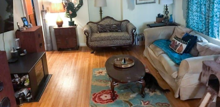 The same living room of the above image, after being cleaned and all clutter removed from it, the normal things you would find in a living room are now visible