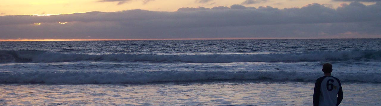 Nate looking out over the ocean at sunset